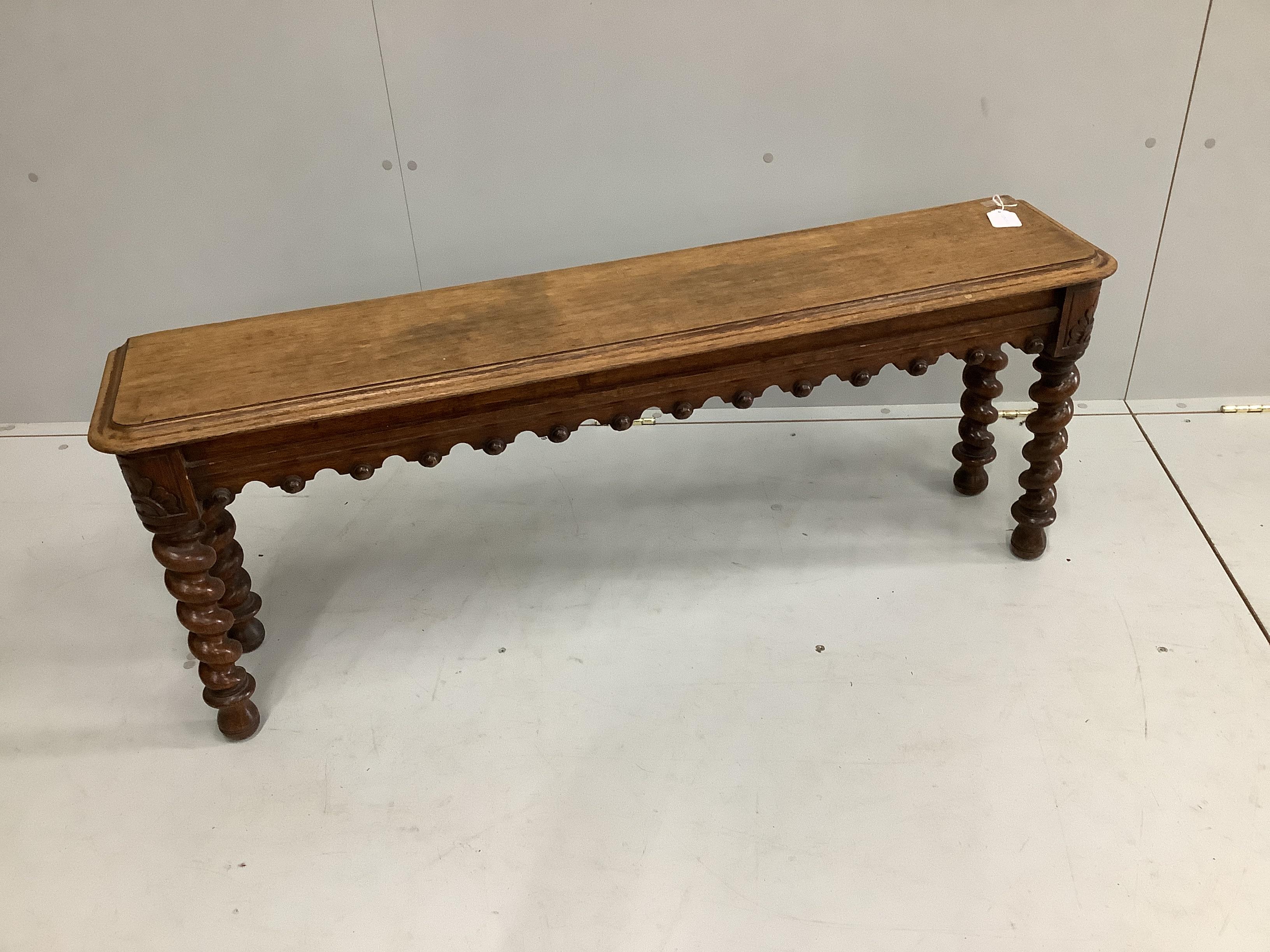 A Victorian oak window seat on spiral turned legs, width 122cm, depth 25cm, height 47cm